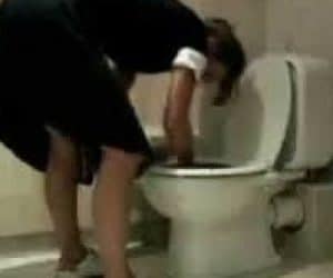 Maid cleaning toilet